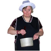A lady wearing an apron and a cook's hat holding a saucepan and stirring with a spoon.