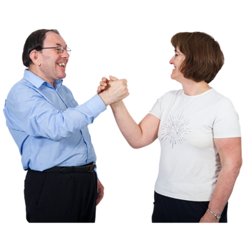 A man and a woman hold hands in the air smiling