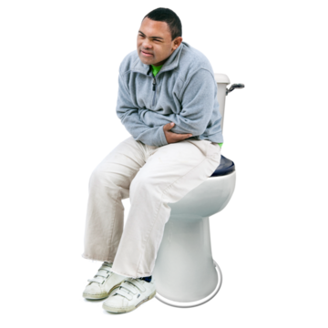 A man is holding his stomach whilst sitting on the toilet
