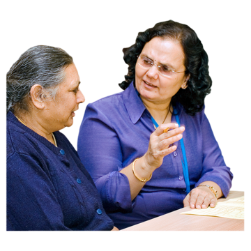 A woman is talking to a woman with a learning disability explaining something to them