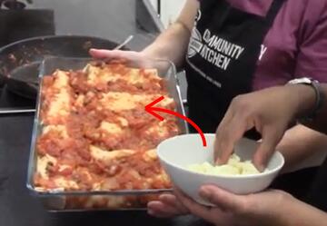 A dish of enchiladas, a bowl of cheese and a red arrow pointing from the cheese to the enchiladas.
