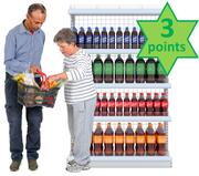 2 people putting items in a shopping basket.  They are standing in front of shelves of bottles which have a label saying 3 points.