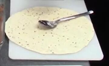 A tortilla wrap and a spoon.