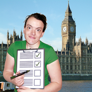 A woman holding a clipboard with the Houses of Parliament behind her.