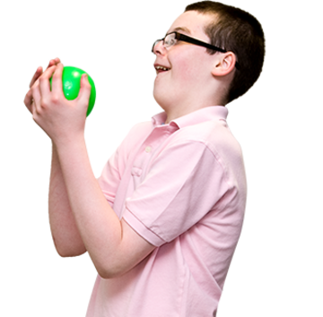 A boy holding a green ball.