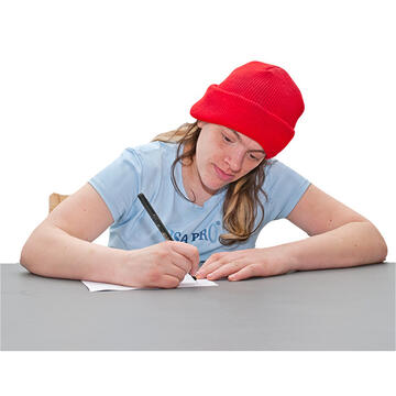 A woman sitting at a table writing.