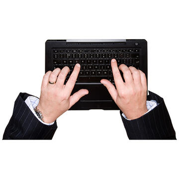 2 hands typing on a keyboard.