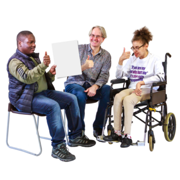 Three people are sitting together and one person is holding a leaflet. All three have their thumbs up