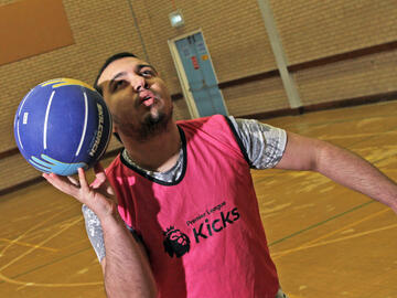 A man about to throw a basketball in the air.