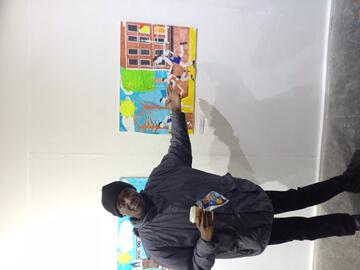A man pointing to a piece of art.