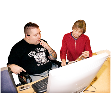 A man sits next to a woman at a computer