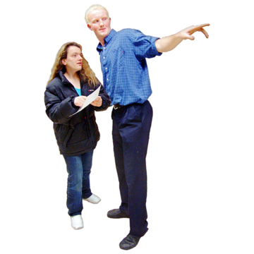 A man pointing to show a woman where something is