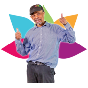 A man with his thumbs up standing in front of a coloured drawing of flower petals