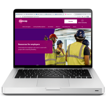 A laptop with the Mencap website on the screen