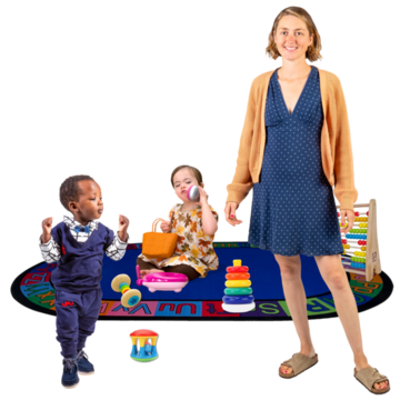 A childminder stands in front of a play mat where two children are playing