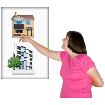 A woman pointing to a picture of a house rather than a picture of an block of flats or offices