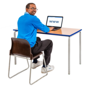 A man searching for a webpage on a laptop sitting at a desk