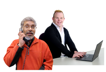 A man on a phone and another man using a laptop