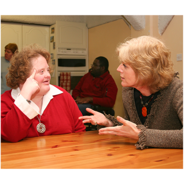 A woman is talking to her landlord in her home