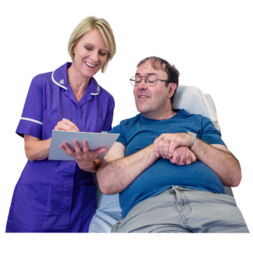 A nurse is filling out a questionnaire for a man next to her who is sat up on a bed