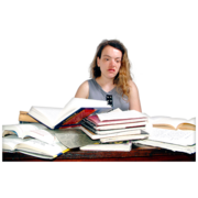 A girl sitting at a desk with lots of open and closed books on it