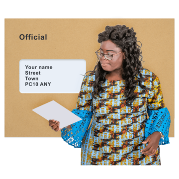 A woman is reading a letter which came out of a brown envelope
