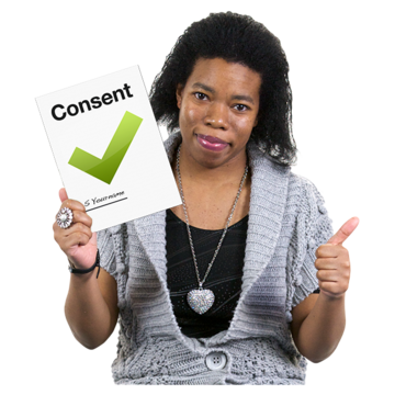 A woman holding up a booklet with a green tick and the word Consent on it.  She also has her thumb up