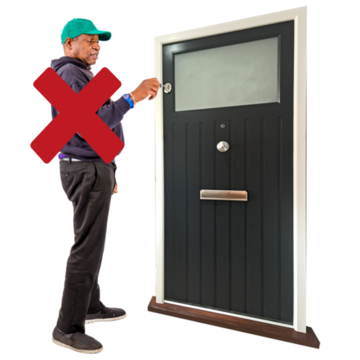 A man is turning a key in the door with a red cross over him.