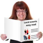 A woman reading an easy read document about events that are happening in her local area.