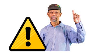 A man with his hand in the air next to a warning sign