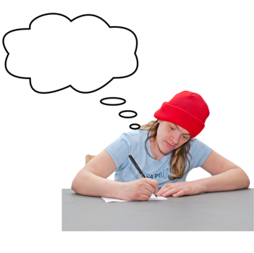 A woman thinking about what to write on a piece of paper sitting at a desk