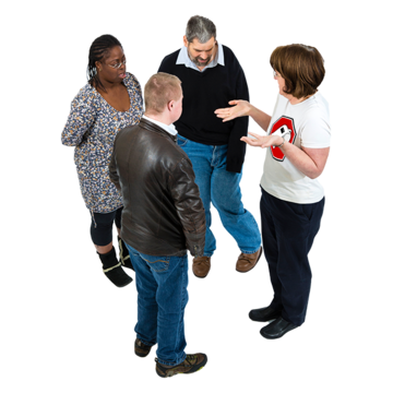 A group of four people are talking to each other