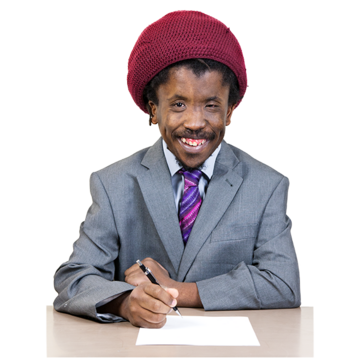 A man in a suit holding a pen and writing a letter on a desk in front of him