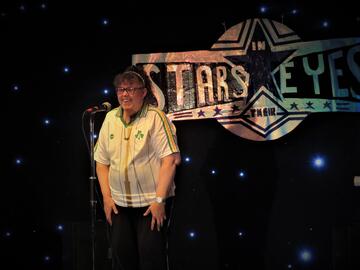 A person standing at a microphone