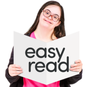 A young woman reading an Easy Read booklet