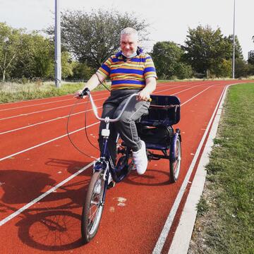 A man going round a track on a bike.