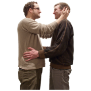 Two men in a relationship hold each other