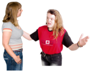 Two women talking - one looks worried and holds her arms out