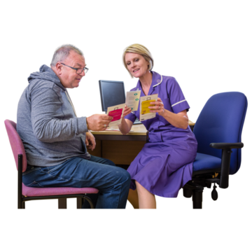 A learning disability nurse is helping a patient read a leaflet