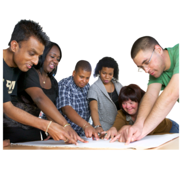 A group of people around a desk pointing to different bits of a large sheet of paper