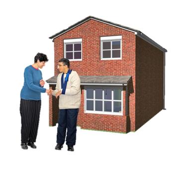 A support worker shaking the hand of someone outside their home