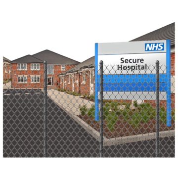A secure hospital with a security fence in front of it