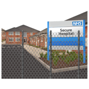 A secure hospital with a security fence in front of it