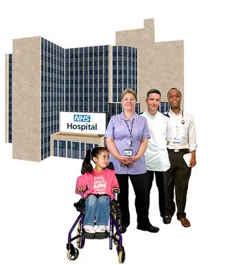 Child in a wheelchair with a doctor and other hospital staff outside a hospital building.
