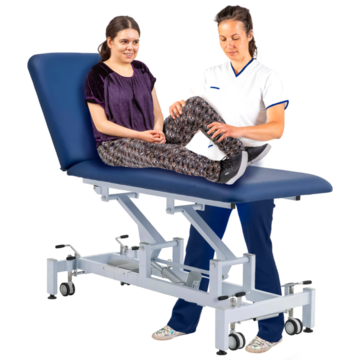 A doctor treating a patient who is sitting on a hospital bed