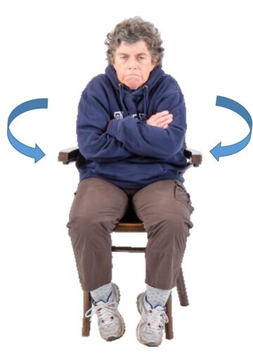 A lady sitting on a chair with cold air blowing around her.