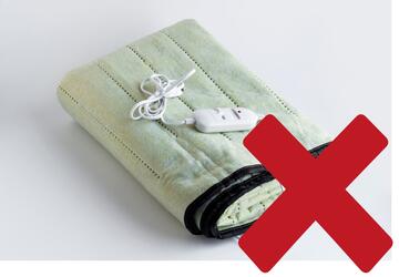 An electric blanket with a red cross over it.