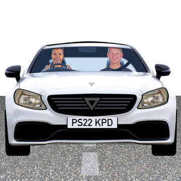 A car with 2 people in it.
