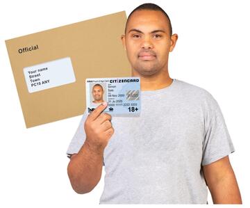 A man holding an ID card and a brown envelope with an address on it.