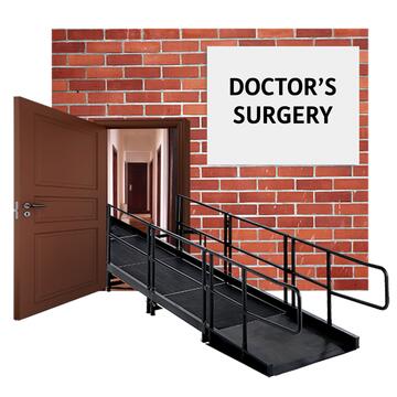 A building with an open door and a ramp up to it. On the wall is a sign which says Doctor's surgery